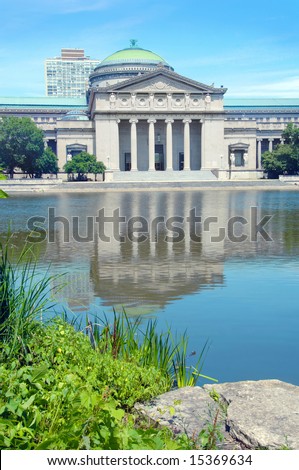 Museum of Science and Industry in Chicago reflected in the water.