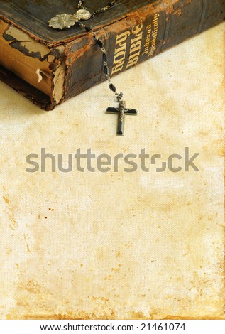 Antique Bible with rosary beads on a grunge background with plenty of copy-space for your text.