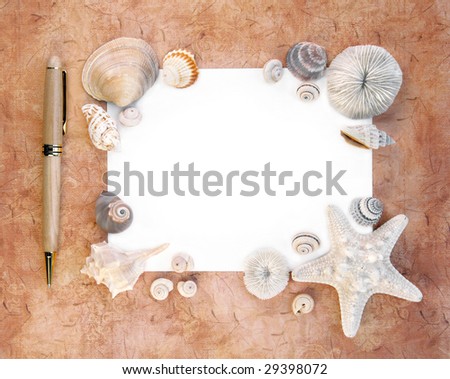 Note paper and pen with sea shells around the border. Blank copy-space for your text.
