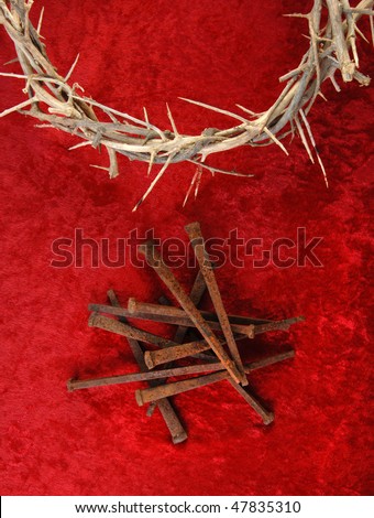 Crown of Thorns and rusty metal spikes on a rich red background.