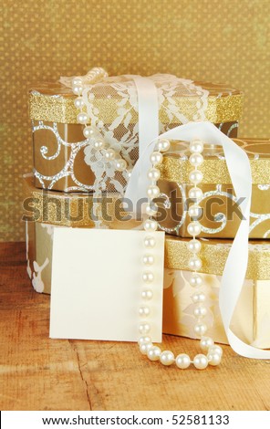 Gift boxes stacked with gold ribbon and gift card blank for your text.
