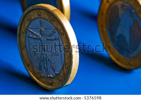 Euro coins rolling on Eu blue flag