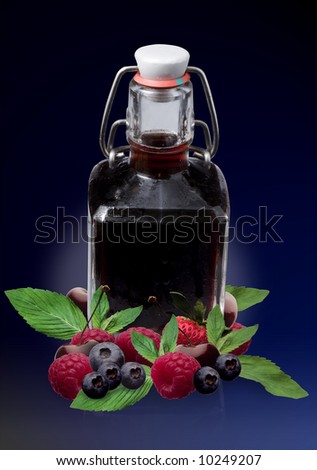 Red spirit in old bottle with red fruits - montage