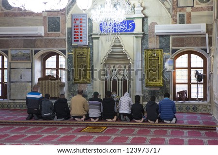 ACRE, ISRAEL-DECEMBER 31 : Muslims pray inside the Acre Mosque on December 31, 2012 in Acre, Israel. The population of Acre is 30% muslim.