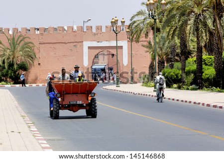MARRAKESH ,MOROCCO - JUNE 4: Unidentified people driving a truck on a street near the Royal Palace in Marrakesh on June 4, 2013 in Morocco. In 2009 the medina got part of UNESCO World Heritage.