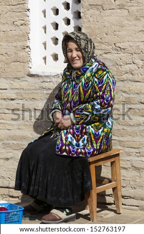 KHIVA, UZBEKISTAN - MARCH 21: Traditionally clouded woman posing for tourist  on March 21, 2012 in Khiva, Uzbekistan. Uzbekistan has great potential for an expanded tourism industry.