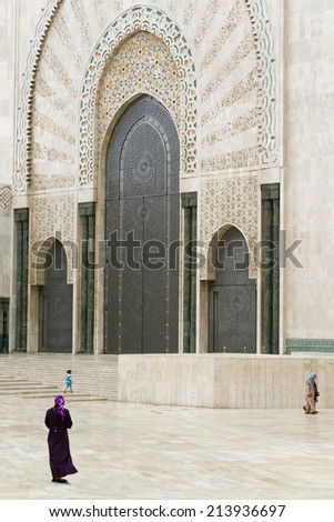 CASABLANCA, MOROCCO - JULY 23: Local people walking at a gate of King Hassan II Mosque on July 23, 2014 in Casablanca, Morocco. It is the largest Mosque in the country