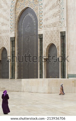 CASABLANCA, MOROCCO - JULY 23: Local people sitting at a gate of King Hassan II Mosque on July 23, 2014 in Casablanca, Morocco. It is the largest Mosque in the country