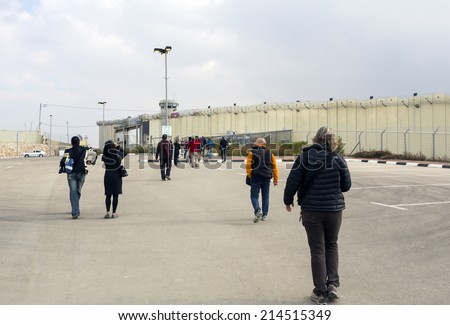 BETHLEHEM, PALESTINE - January 2: Unidentified people passing the wall between Israel and Palestine on Januray 2, 2013 in Bethlehem, Palestine.