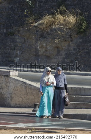 RABAT - JULY 23: Traditional clothed women crossing the road on July 23, 2014 in Rabat, Morocco. The city is located on the Atlantic Ocean at the mouth of the river Bou Regreg Rabat, Morocco.