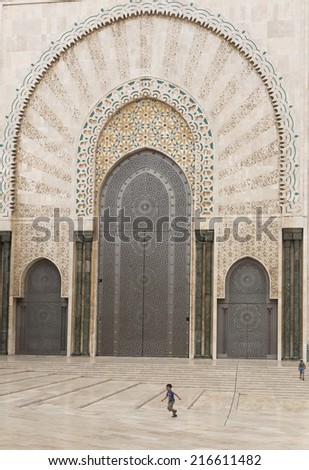 CASABLANCA, MOROCCO - JULY 23: Child playing at a gate of King Hassan II Mosque on July 23, 2014 in Casablanca, Morocco. It is the largest Mosque in the country