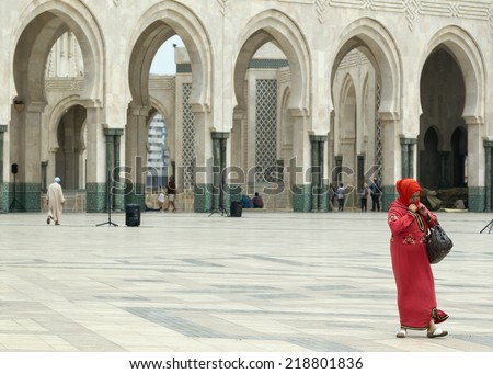 CASABLANCA, MOROCCO - JULY 23: Local woman walking at the King Hassan II Mosque on July 23, 2014 in Casablanca, Morocco. It is the largest Mosque in the country