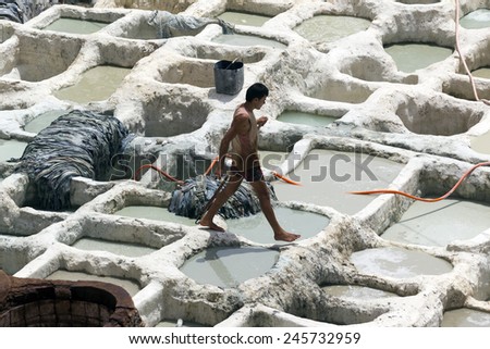 FEZ, MOROCCO - JULY 19: Worker in the tannery souk of weavers on July 19, 2014 in Fez, Morocco. The tannery souk of weavers is the most visited part of the 2000 years old city.