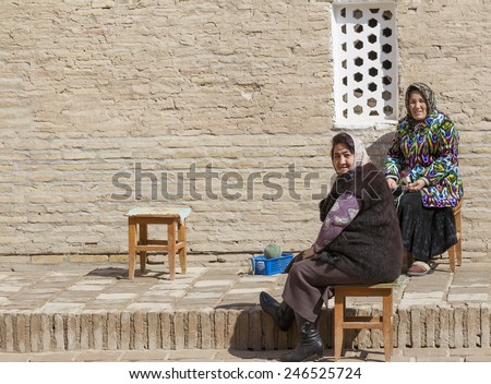 KHIVA, UZBEKISTAN - MARCH 21: Traditionally clouded women posing for tourist  on March 21, 2012 in Khiva, Uzbekistan. Uzbekistan has great potential for an expanded tourism industry.