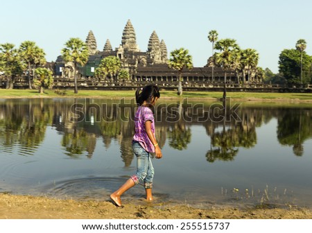 SIEM REAP, CAMBODIA - JANUARY 3 : Girl playing at the famous Angkor Wat Temple on January 3, 2014 near Siem Reap, Cambodia.