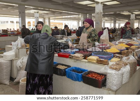 SAMARQUAND, UZBEKISTAN - MARCH 23: Unidentified women sell goods on the main market on March 23, 2012 in Samarquand, Uzbekistan. The ancient city is part of UNESCO World Heritage.