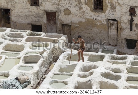 FEZ, MOROCCO - JULY 19: Worker  in the tannery souk of weavers on July 19, 2014 in Fez, Morocco. The tannery souk of weavers is the most visited part of the 2000 years old city.