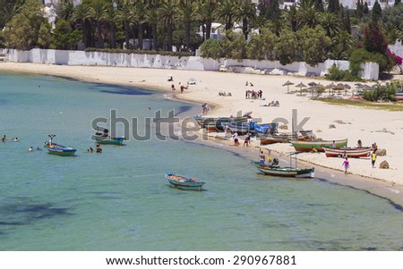 HAMMAMET, TUNISIA - JUNE 25: People on the beachon June 25, 2011 in Hammamet, Tunisia. Due to its beaches it is a popular destination for swimming and water sports.