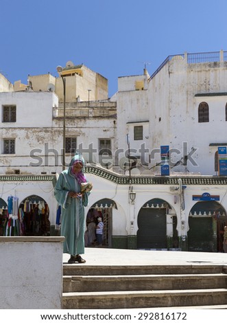 MULAY IDRISS, MOROCCO - JULY 22: Woman on a street on July 22, 2014 in Mulay Idriss. King Moulay Idriss I arrived here in 789, bringing with him the religion of Islam, and starting a new dynasty.