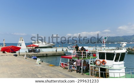 BATUMI, GEORGIA - JULY 20, 2015: Unidentified people visit the port in Batumi. With a population of 190,000 Batumi serves as an important port and a commercial center.