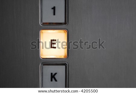 Illuminated basement button in an elevator.