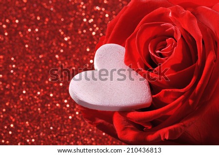 Pink heart in red rose on red sparkle background