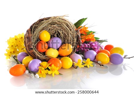 original easter eggs in yellow, violet and orange with flowers and easter nest on white background