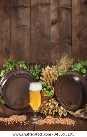 two beer barrels with beer glass, hops, wheat, grain, barley and malt