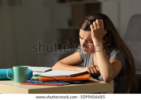 Tired student studying hard late hours in the night at home