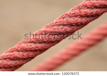 Tight red ropes. Unfocused background