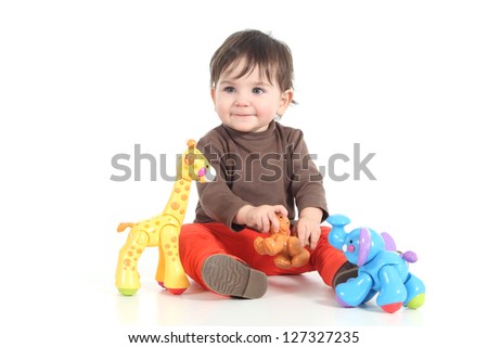 Baby playing with colorful animal toys on a white isolated background Baby playing with colorful animal toys on a white isolated background