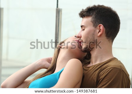 Attractive couple kissing with love and passion outside