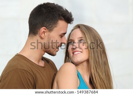 Close up of a beautiful couple looking each other with love outdoor