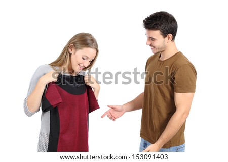 Happy couple shopping and trying clothes isolated on a white background