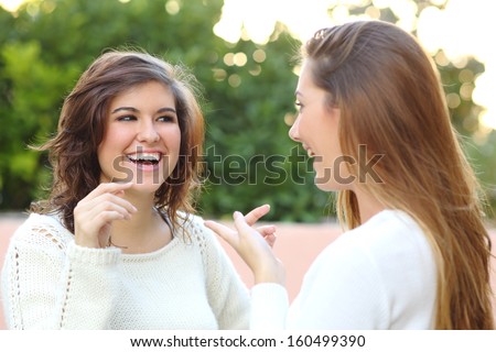 Two young women talking happy outdoor