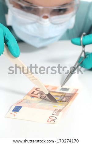 Surgeon operating a banknote crisis and economic depression concept