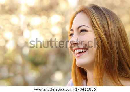 Facial Portrait Of A Funny Woman Face Laughing With A Warmth Background