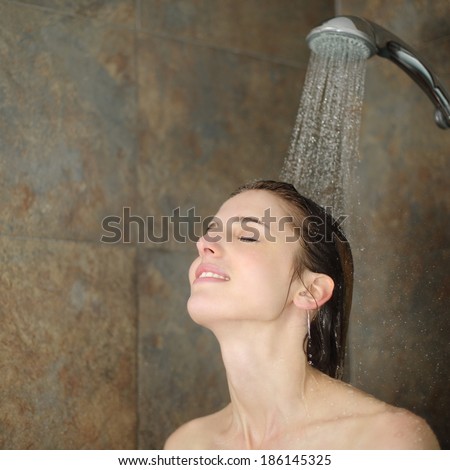 Relaxed woman showering in a shower with a water jet