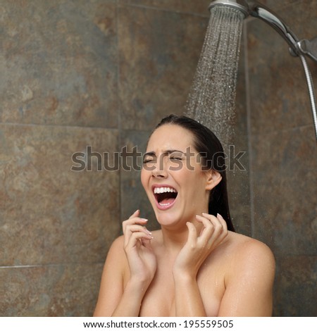 Disgusted woman screaming in the shower under a cold water jet