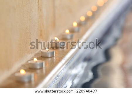 Close up of burning candles near water in a spa interior pool relax concept