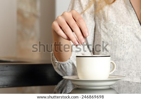 Woman hand preparing a cup of coffee at home