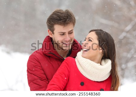 Couple falling in love at first sight in winter outdoors while snowing