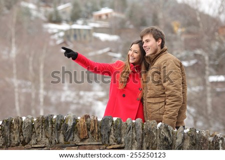 Happy couple of tourists crossing a bridge in winter holidays