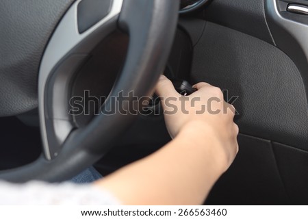 Closeup of a driver hand starting the car with the key