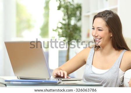 Casual woman using a laptop to browse internet at home