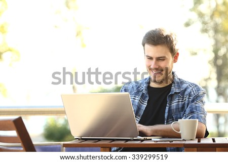 Entrepreneur man working with a laptop in a restaurant terrace or home balcony