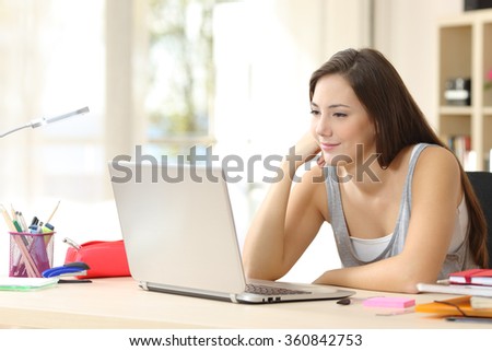Student studying and learning online with a laptop in a desk at home