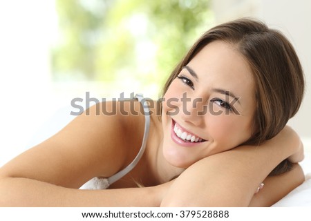 Beauty girl with white teeth and perfect smile looking at camera at home