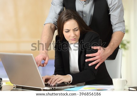 Harassment with a boss touching the arm to his secretary who is sitting in his workplace at office