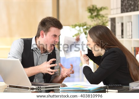 Two angry businesspeople arguing furious showing a negative growth graph at office